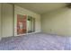 View of a covered patio featuring stone pavers and a sliding glass door at 14285 Crest Palm Ave, Windermere, FL 34786