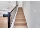 Elegant wooden staircase with black metal railing in a modern home interior at 14285 Crest Palm Ave, Windermere, FL 34786