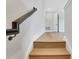 Ascending wooden staircase featuring a modern dark metal handrail and white trim at 14285 Crest Palm Ave, Windermere, FL 34786