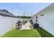 Side yard with white fence, grill, air conditioning unit, and plenty of open space at 15022 Se 94Th Ct, Summerfield, FL 34491