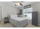 This bedroom has a bed, ceiling fan, window and Winchester safe at 15022 Se 94Th Ct, Summerfield, FL 34491