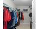Walk-in closet with ample hanging space and shelving, perfect for organizing clothes and accessories at 15022 Se 94Th Ct, Summerfield, FL 34491