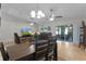 Open concept dining area with a dark wood table, tile floors, and sliding glass doors leading to the backyard at 15022 Se 94Th Ct, Summerfield, FL 34491