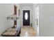 Welcoming foyer featuring a decorative table with a lamp, and tile flooring at 15022 Se 94Th Ct, Summerfield, FL 34491