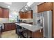 Spacious kitchen featuring a large island, stainless steel refrigerator, and ample counter space at 15022 Se 94Th Ct, Summerfield, FL 34491