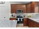 Modern kitchen with stainless steel appliances, granite countertops, and plenty of cabinet storage space at 15022 Se 94Th Ct, Summerfield, FL 34491