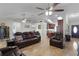 Open-concept living space with tile flooring, leather recliners, vaulted ceilings and abundant natural light at 15022 Se 94Th Ct, Summerfield, FL 34491