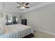 Main bedroom with tray ceilings, neutral decor, and great lighting from a large window at 15022 Se 94Th Ct, Summerfield, FL 34491