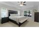 Cozy main bedroom with a tray ceiling, neutral colors, and lots of natural light at 15022 Se 94Th Ct, Summerfield, FL 34491