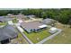 Aerial view of the backyard, featuring a screened-in patio, fenced yard and a storage shed at 15022 Se 94Th Ct, Summerfield, FL 34491