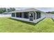 The screened porch area in the fenced backyard is perfect for outdoor entertaining at 15022 Se 94Th Ct, Summerfield, FL 34491