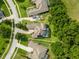 Aerial view showing home with screened pool, mature landscaping, and circular driveway at 16951 Florence View Dr, Montverde, FL 34756