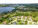 Community aerial showcasing lake, sports fields, water tower and lush homes in the neighborhood at 16951 Florence View Dr, Montverde, FL 34756