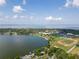 An aerial view showcasing the community's lakefront location, sports fields, and beautiful city views at 16951 Florence View Dr, Montverde, FL 34756