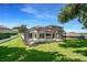A expansive backyard view showcasing the pool and screen enclosure with lush green grass at 16951 Florence View Dr, Montverde, FL 34756