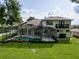 A spacious backyard featuring a screened-in pool, lush green lawn, and an outdoor living area with lots of privacy at 16951 Florence View Dr, Montverde, FL 34756
