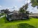 Spacious backyard featuring a screened-in pool, lush green lawn, and an outdoor living area with lots of privacy at 16951 Florence View Dr, Montverde, FL 34756