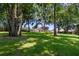 Spacious backyard with lush greenery and mature trees provides a private oasis at 16951 Florence View Dr, Montverde, FL 34756