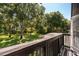 A gorgeous backyard view from a balcony featuring a lush green lawn and mature trees at 16951 Florence View Dr, Montverde, FL 34756
