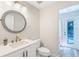 Bathroom featuring modern vanity, stylish mirror, and pool access at 16951 Florence View Dr, Montverde, FL 34756