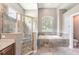 Bathroom featuring shower, tub, tile flooring, and toilet at 16951 Florence View Dr, Montverde, FL 34756