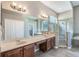 Primary bathroom with double sinks, soaking tub, glass shower, and closet at 16951 Florence View Dr, Montverde, FL 34756