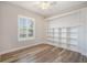 Bright bedroom with large windows, recessed lighting, and custom built-in shelving for storage and display at 16951 Florence View Dr, Montverde, FL 34756