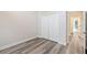 Bedroom featuring closet, doorway to pool, and wood look flooring at 16951 Florence View Dr, Montverde, FL 34756