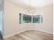 Dining area with natural light from bay window, decorative chandelier, and a view of the outdoor pool at 16951 Florence View Dr, Montverde, FL 34756