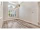 Formal dining room featuring luxury vinyl flooring, coffered ceiling, and plantation shutters at 16951 Florence View Dr, Montverde, FL 34756