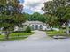 Beautiful home featuring stone accents, a circular paved driveway, manicured landscaping and a white exterior at 16951 Florence View Dr, Montverde, FL 34756