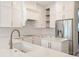 Kitchen showcasing a sink and stainless appliances, enhanced by white cabinets, backsplash, and a kitchen island at 16951 Florence View Dr, Montverde, FL 34756