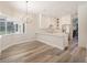 Open concept kitchen featuring white cabinetry and stainless appliances, adjoining an adjacent dining area at 16951 Florence View Dr, Montverde, FL 34756