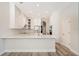 Bright modern kitchen featuring large counter, white cabinetry, stainless appliances, and eat-in area at 16951 Florence View Dr, Montverde, FL 34756