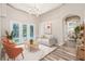 Staged living room with luxury vinyl flooring, modern sofa, and sliding glass doors to the lanai at 16951 Florence View Dr, Montverde, FL 34756