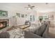 Stylishly furnished living room with a stone fireplace, neutral decor, and seamless transition to the outdoor area at 16951 Florence View Dr, Montverde, FL 34756