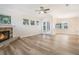 Spacious living room features a stone fireplace, neutral walls, hardwood floors, and an outdoor view at 16951 Florence View Dr, Montverde, FL 34756