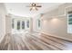 Spacious main bedroom with hardwood flooring and multiple windows, allowing for lots of natural light at 16951 Florence View Dr, Montverde, FL 34756