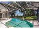 A beautiful screened-in pool and patio area featuring a rock feature and peaceful backyard views at 16951 Florence View Dr, Montverde, FL 34756