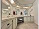 Well-lit bathroom featuring double sinks, vanity space, and decorative mirrors and lighting at 175 Hibiscus Way, Leesburg, FL 34748