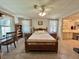 Bedroom with neutral carpet, ceiling fan, furnishings and ensuite bathroom at 175 Hibiscus Way, Leesburg, FL 34748
