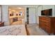 Bedroom with neutral carpet, wooden furnishings, ensuite bathroom and walk-in closet at 175 Hibiscus Way, Leesburg, FL 34748