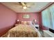 Inviting bedroom with floral bedspread, accent pillows, and ample natural light at 175 Hibiscus Way, Leesburg, FL 34748