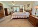 Bedroom with neutral carpet, ceiling fan, and wooden furnishings at 175 Hibiscus Way, Leesburg, FL 34748