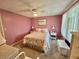 Inviting bedroom with floral bedspread, accent pillows, and ample natural light at 175 Hibiscus Way, Leesburg, FL 34748