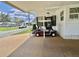 Carport featuring a red golf cart parked underneath a bright, covered area at 175 Hibiscus Way, Leesburg, FL 34748