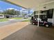 Spacious carport featuring a golf cart and additional parking at 175 Hibiscus Way, Leesburg, FL 34748