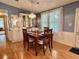 Cozy dining room with hardwood floors and a decorative chandelier illuminating the space at 175 Hibiscus Way, Leesburg, FL 34748