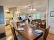 Open-concept dining room with wood floors and chandelier lighting at 175 Hibiscus Way, Leesburg, FL 34748