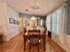 Well-lit dining area with wood floors, traditional furniture, and plenty of space at 175 Hibiscus Way, Leesburg, FL 34748